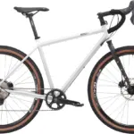 Graues Stahl-Gravelbike mit Dropbar-Lenker, breiten Reifen und Scheibenbremsen, das für Bikepacking und Abenteuer konzipiert ist.