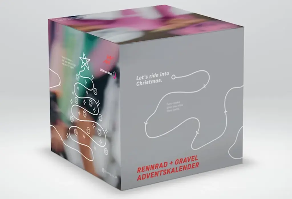 Velocità Adventskalender 2025 in grauer Box mit festlichem Design und Aufschrift Rennrad + Gravel Adventskalender