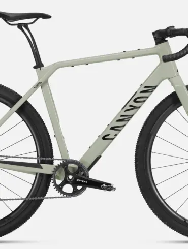 Seitenansicht eines Canyon Grizl CF 8 Di2 Gravelbikes in hellgrüner Lackierung mit schwarzen Canyon GR 30 CF Carbon-Laufrädern und Schwalbe G-One RX Reifen.