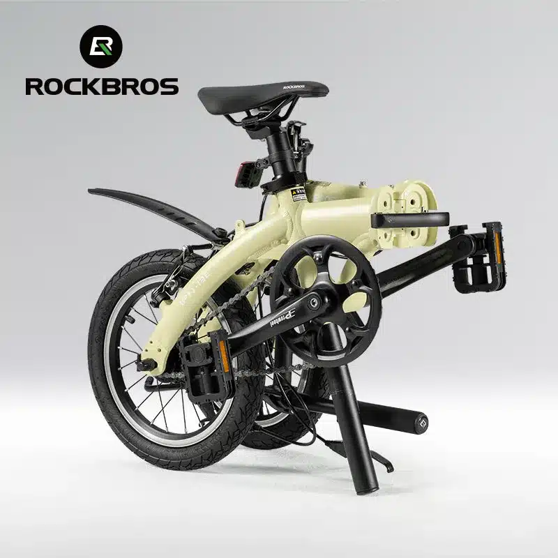 Ein beiges ROCKBROS IFN 14-Zoll-Faltrad ist seitlich dargestellt. Das Fahrrad ist zum Transport zusammengeklappt, mit sichtbarem Lenker und Pedalen.