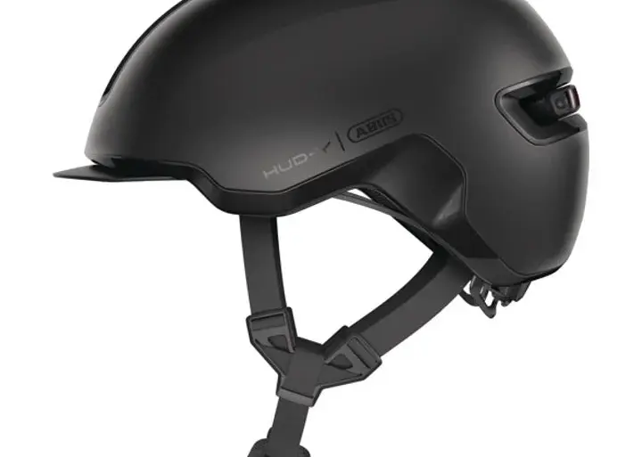Seitenansicht des schwarzen Abus Hud-Y Fahrradhelms mit Visier und integriertem Rücklicht