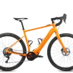 Orangefarbenes Böttcher Gravel-E SX E-Gravelbike mit schwarzen Reifen und Anbauteilen, freigestellt vor weißem Hintergrund.