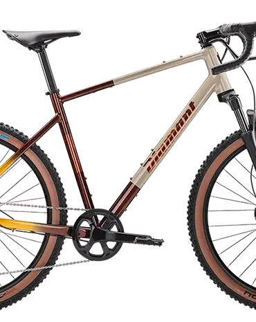 Ein hellbeiges und rot-gelb verlaufendes Diamant 140 Gravelbike mit braunen Reifen und schwarzer Federgabel.