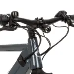 Nahaufnahme des linken und rechten Lenkers eines grauen SD3 URBAN E-Bikes mit Fokus auf den Griff, die Magura Bremse, die Klingel, den Supernova Scheinwerfer, das Bosch Purion Display und die Verkabelung.