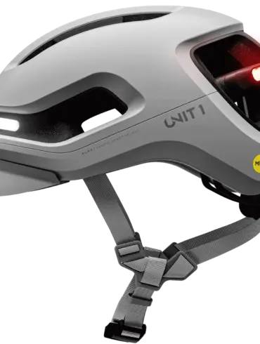 Grauer UNIT 1 AURA Mips Smart-Helm mit integriertem weißem Frontlicht und rotem Rücklicht, Mips-Logo und Belüftungsöffnungen.