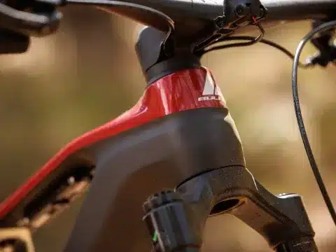 Nahaufnahme des roten und schwarzen Rahmens am Steuerrohr eines BULLS SONIC EN-R TEAM E-Enduro Fahrrads, mit Fokus auf das BULLS-Logo.