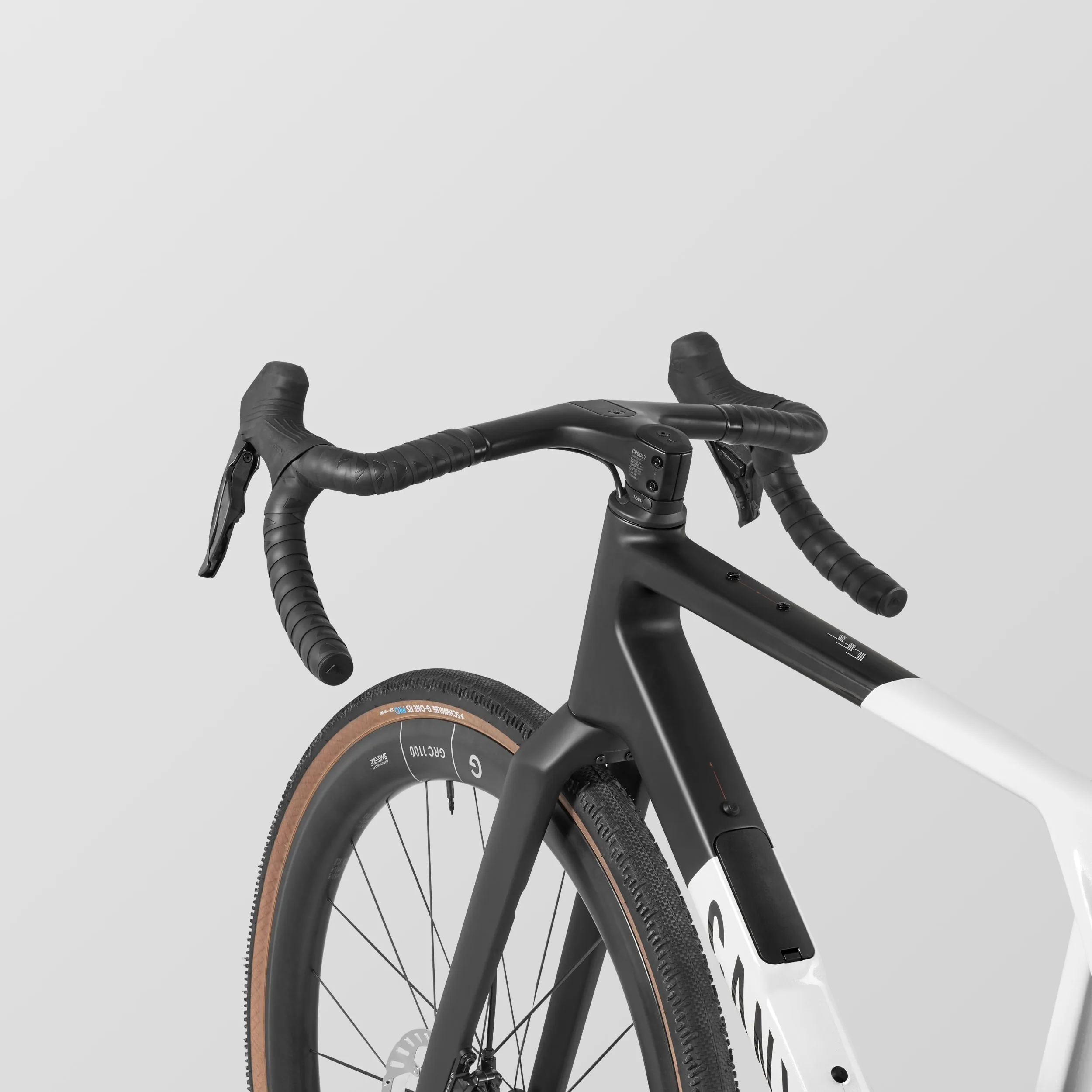 Vorderansicht eines Canyon Grail CFR Di2 Gravelbikes mit Fokus auf Lenker, Vorbau, elektronische Schaltung und Carbonlaufrad mit dem Schriftzug GRC 1100.