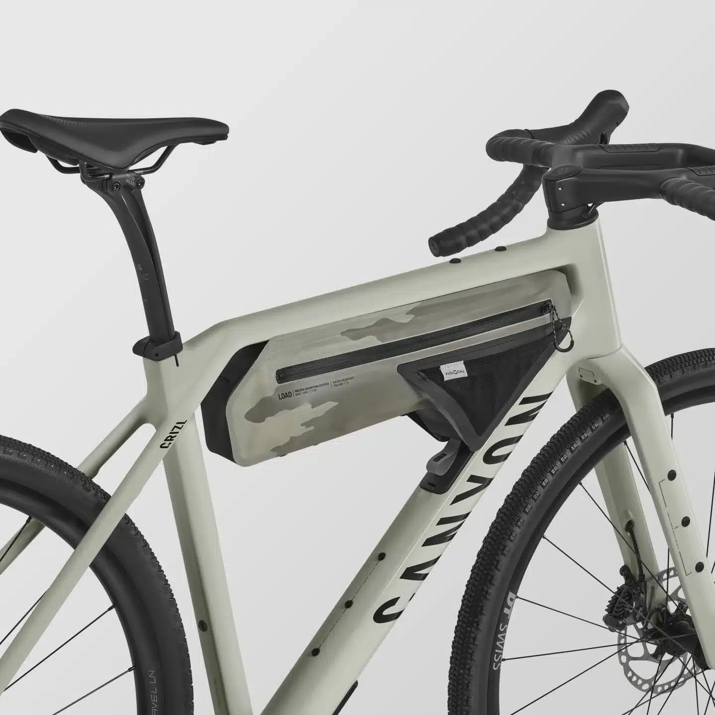 Nahaufnahme des Canyon Grizl CF 7 ESC Gravelbikes mit einer olivgrünen Camouflage-Rahmentasche im Hauptrahmen.