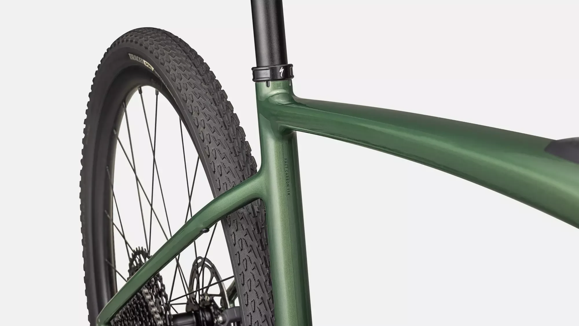 Detailansicht des grünen Carbonrahmens eines Specialized Turbo Creo 2 Comp E-Gravelbikes mit Fokus auf das Hinterrad und den Reifen.