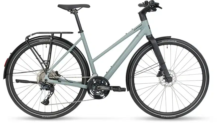 Seitenansicht eines grauen Stevens Kalea 7.1 LT Urban Bikes mit Gepäckträger, Schutzblechen und Lichtanlage.