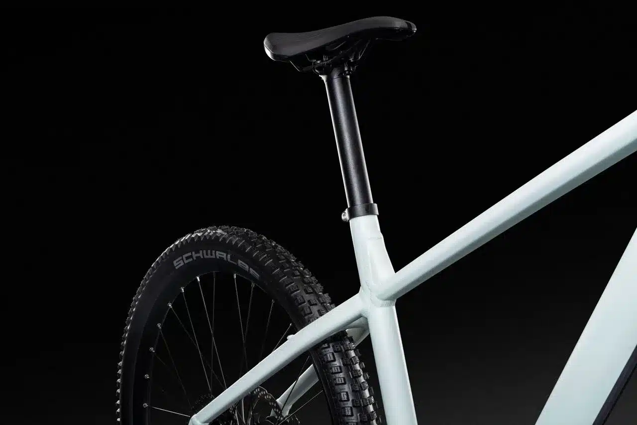 Detailansicht eines hellblauen Lapierre E-Mountainbike Hardtails, Fokus auf Rahmengeometrie, Sattelstütze und Profil des Schwalbe Reifens.
