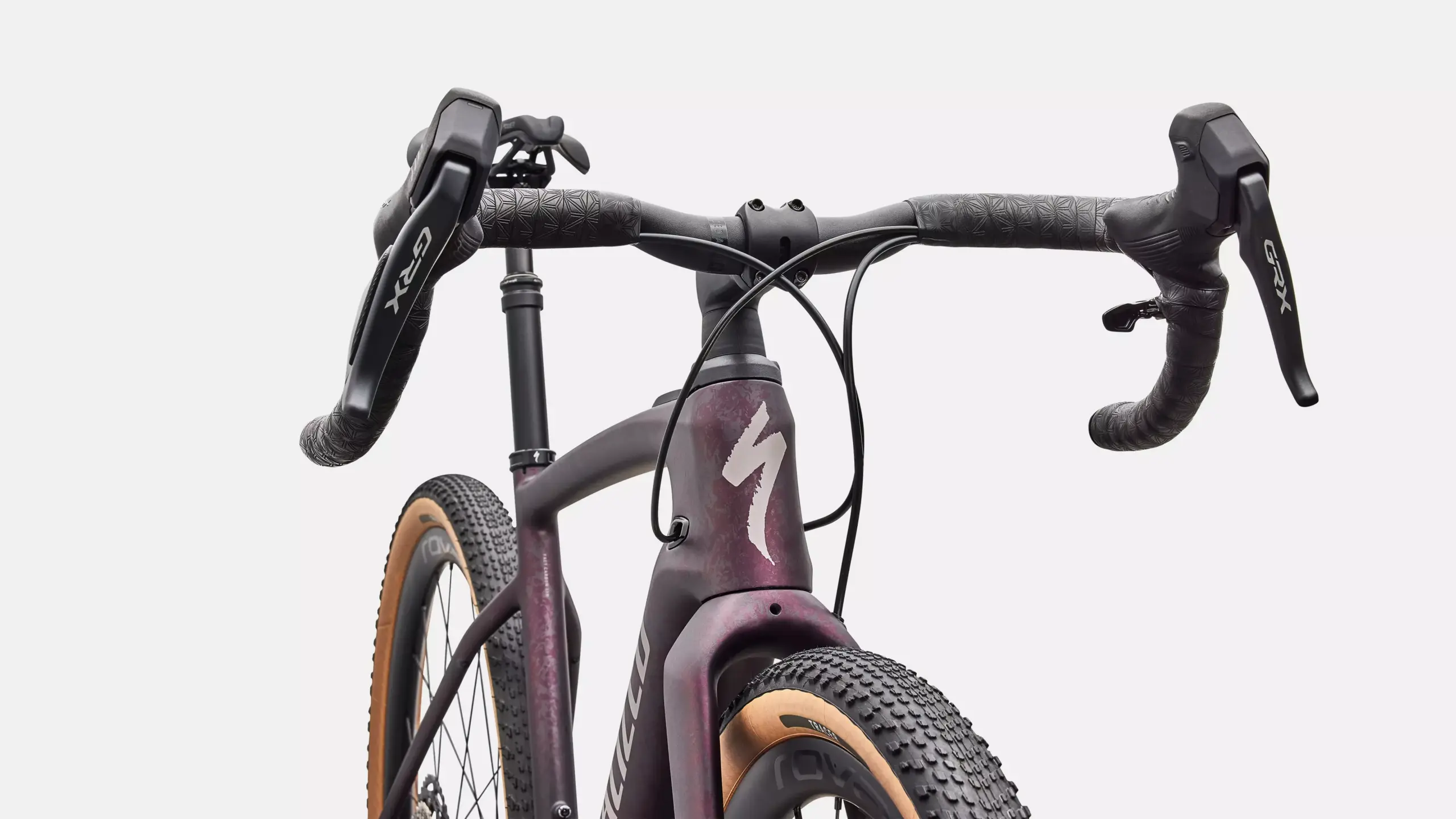 Detailaufnahme des Specialized Turbo Creo 2 Expert E-Gravelbikes mit Fokus auf Lenker, Bremshebel und Vorderreifen.