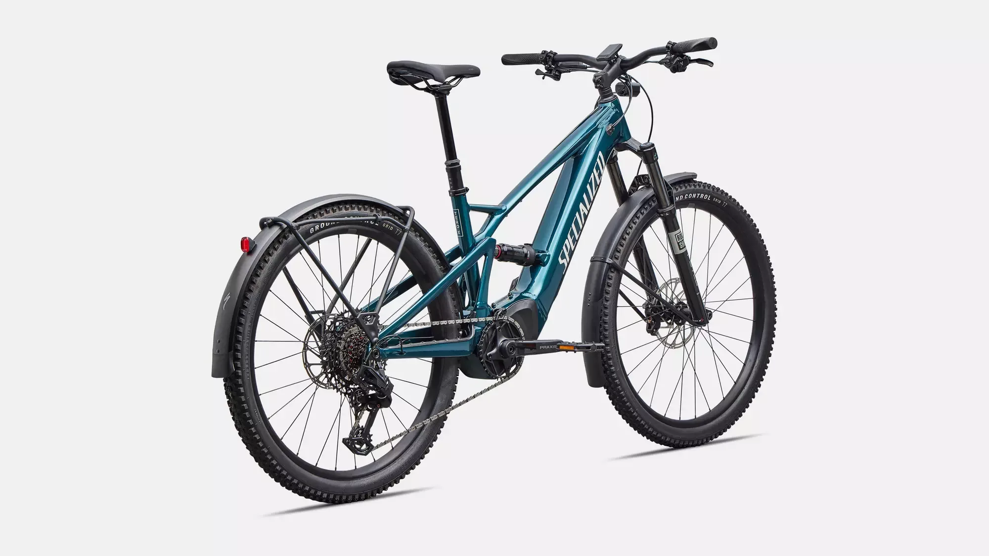 Spezialisiertes Turbo Tero X 5.0 E-Bike in smaragdgrün mit vollgefedertem Rahmen, Gepäckträger und Schutzblechen.