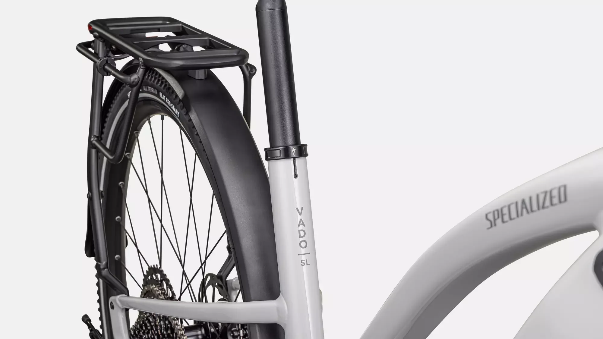 Detailaufnahme eines weißen Specialized Turbo Vado SL 2 5.0 Step-Through EQ E-Bikes am Heck, mit Fokus auf den integrierten Gepäckträger, das Schutzblech und das VADO SL Schriftlogo.