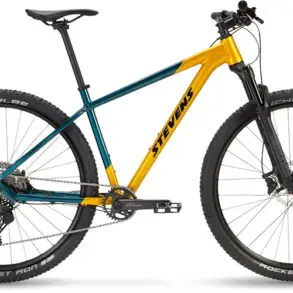 Seitenansicht eines Stevens Devil's Trail Mountainbikes in Gelb-Türkis mit schwarzen Reifen und Federgabel.