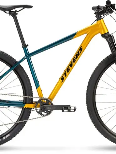 Seitenansicht eines Stevens Devil's Trail Mountainbikes in Gelb-Türkis mit schwarzen Reifen und Federgabel.