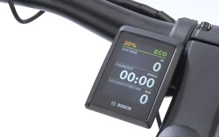 Nahaufnahme des Bosch Kiox 300 Displays an einem E-Bike Lenker, das Informationen wie Distanz, Fahrzeit und Gesamtdistanz anzeigt.