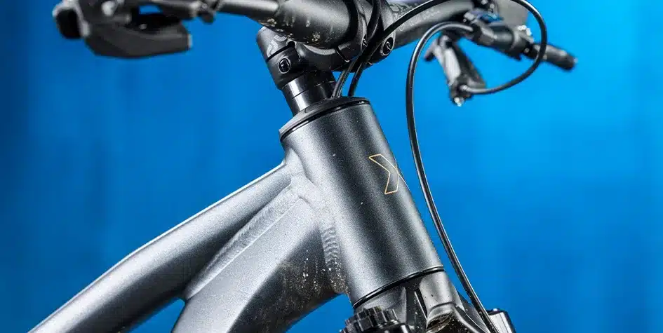 Detaillierte Ansicht des vorderen Rahmens eines grauen Fab4 29 Zoll Mountainbikes mit Lenker und Gabelansatz.