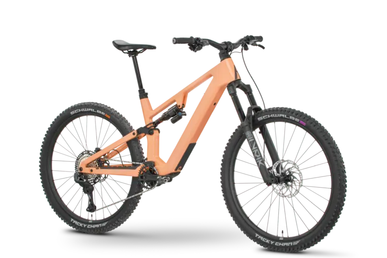 Rose File Plus XT E-MTB in der Farbe Koralle, von der Seite fotografiert mit einem schwarzen Hintergrund.