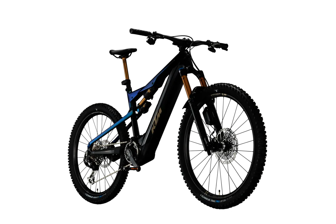 Ein schwarzes KTM E-Mountainbike mit blauen Akzenten und goldenen Federungselementen, von vorne gesehen.